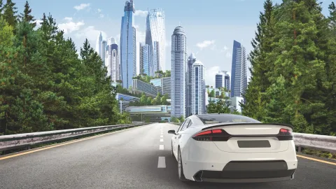 Car in front of a city skyline