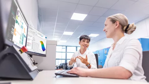 two people in front of a computer