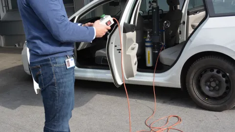 photo of man standing before car