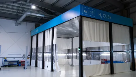 A H2 Cube with floor to ceiling plastic containment material and a blue sign at the top