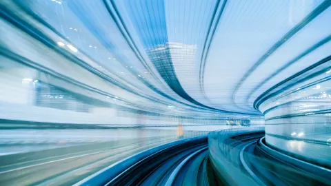 pov of train running through bright tunnel, motion is blurred