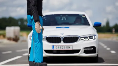 Car approaching pedestrian dummy on proving ground
