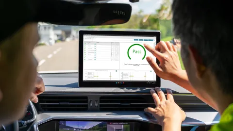 Immediate evaluation of test results after proving ground test, two men looking at screen