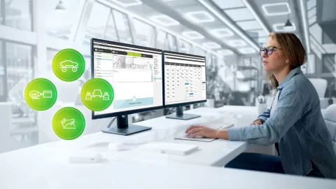 Woman sitting at desk infront of two screen
