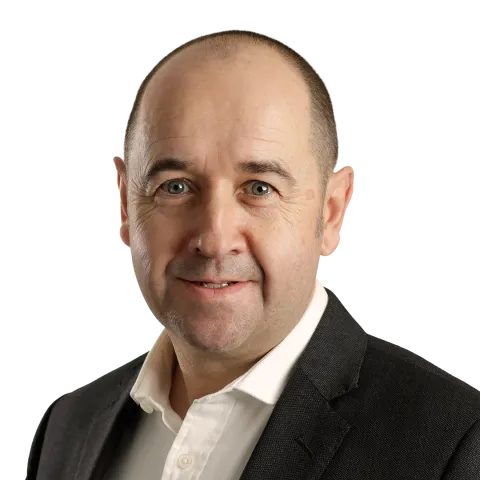 headshot of Martin McCormack wearing a white shirt and black suit jacket