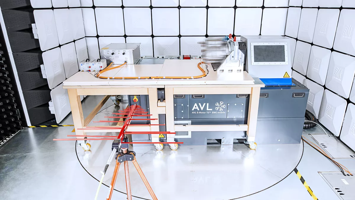  An image showing a technician setting up electronic equipment for OPTIMIZE AN EMI & EMC TEST, with cables and testing instruments arranged on a lab bench.